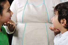 two kids listening to mother