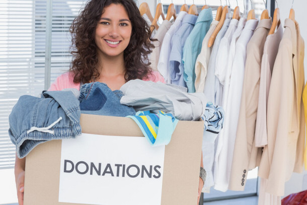 Volunteer taking clothing donations