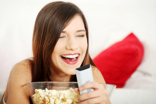 Girl laughing at tv show