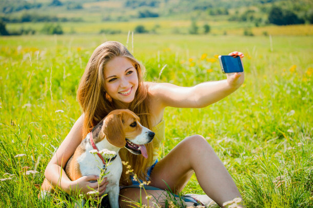 teenage girl relaxing with her dog