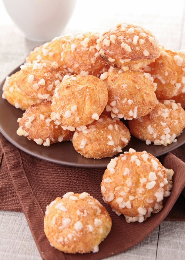 Chouquettes are a plum shaped pastry, or chou as it is called in french, is made into a ball and topped off with some little chunks of sugar.