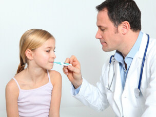 Doctor checking a child's fever