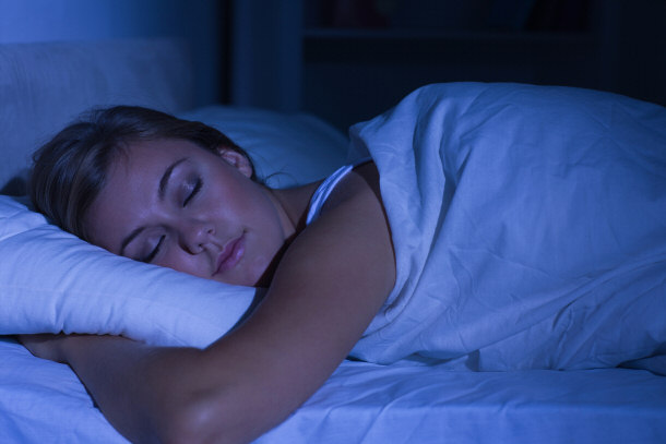 woman sleeping in darkened room