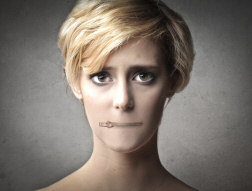 woman with mouth zipped