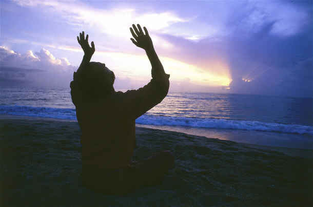 Praying or meditating on the beach
