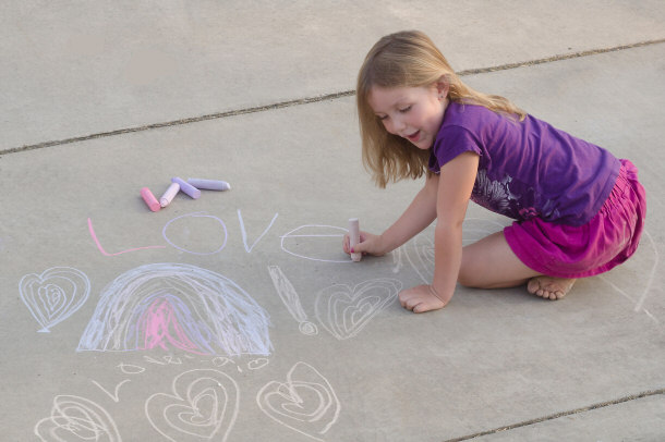 little girl playing with chalk