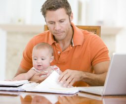 Man working while also taking care of baby