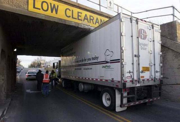 truck hitting low clearance sign