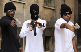 Gang members holding guns