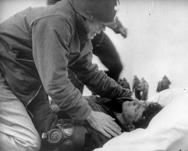 Lt. Commander Joseph T. O'Callahan Giving Last Rites to an Injured Crewman