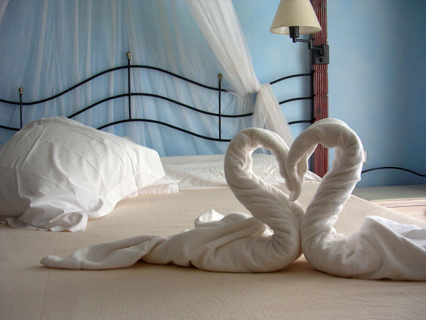 sheets arranged in heart on bed