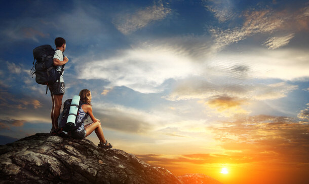 Happy couple out hiking and climbing