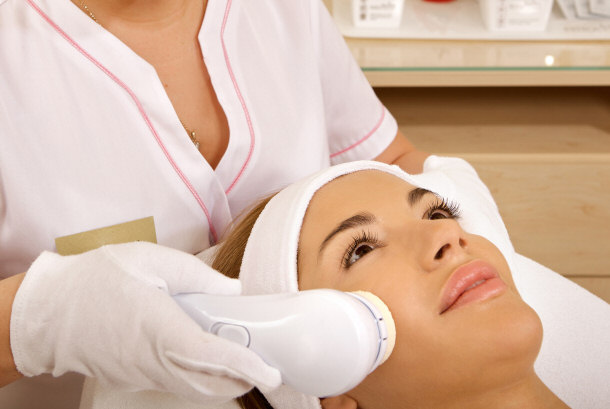 Laser hair removal on face in a professional studio.