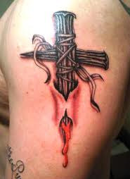 Bloody Cross Tattoo on shoulder
