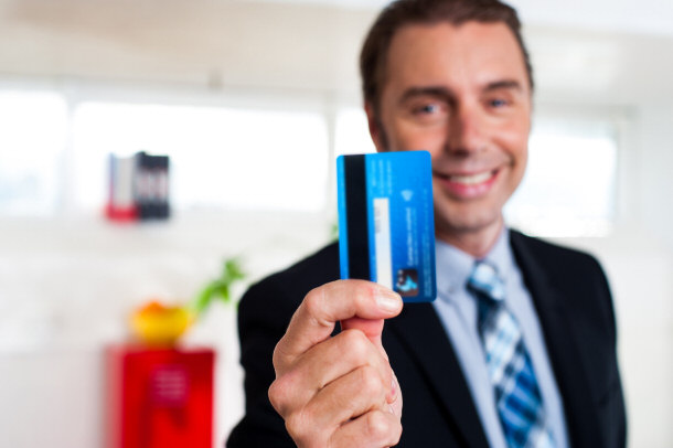 businessman holding credit card