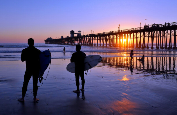 Surfers standing on beach