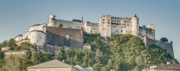 Located in Salzburg, Austria, the Hohensalzburg Castle sits on a beautiful mountain with a water view. 