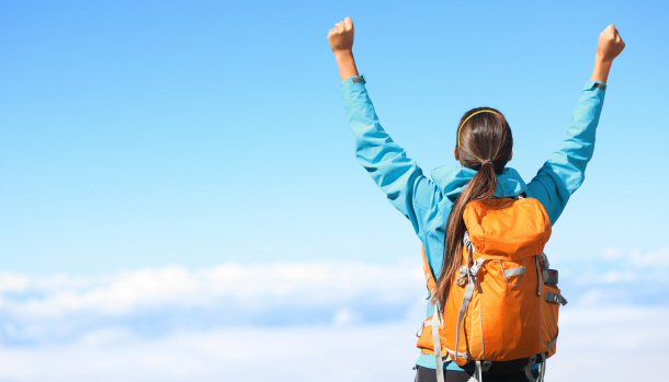 Woman conquering mountain climb