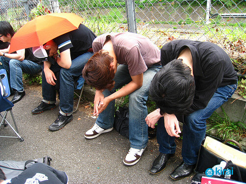 young japanese kids sleeping on bench