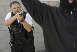 police officer pointing gun at criminal
