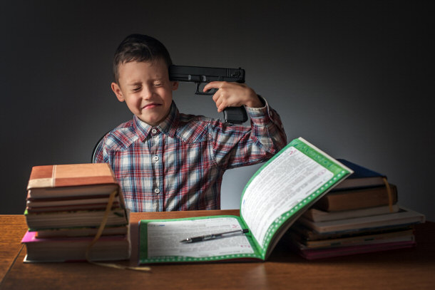 young boy with gun pointed at his head