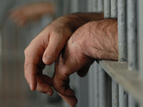Hands behind bars