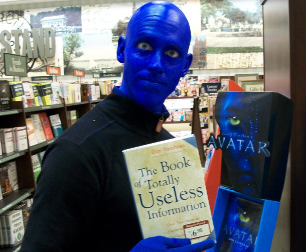 Blue Man Boosts confidence by reading something totally useless.
