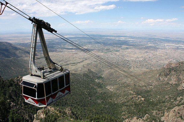 The Sandia Peak Tramway is a Swiss built cable car system that lifts visitors from the city up to the top of the Sandia Mountains, a rise in elevation of about 4,000 feet. 